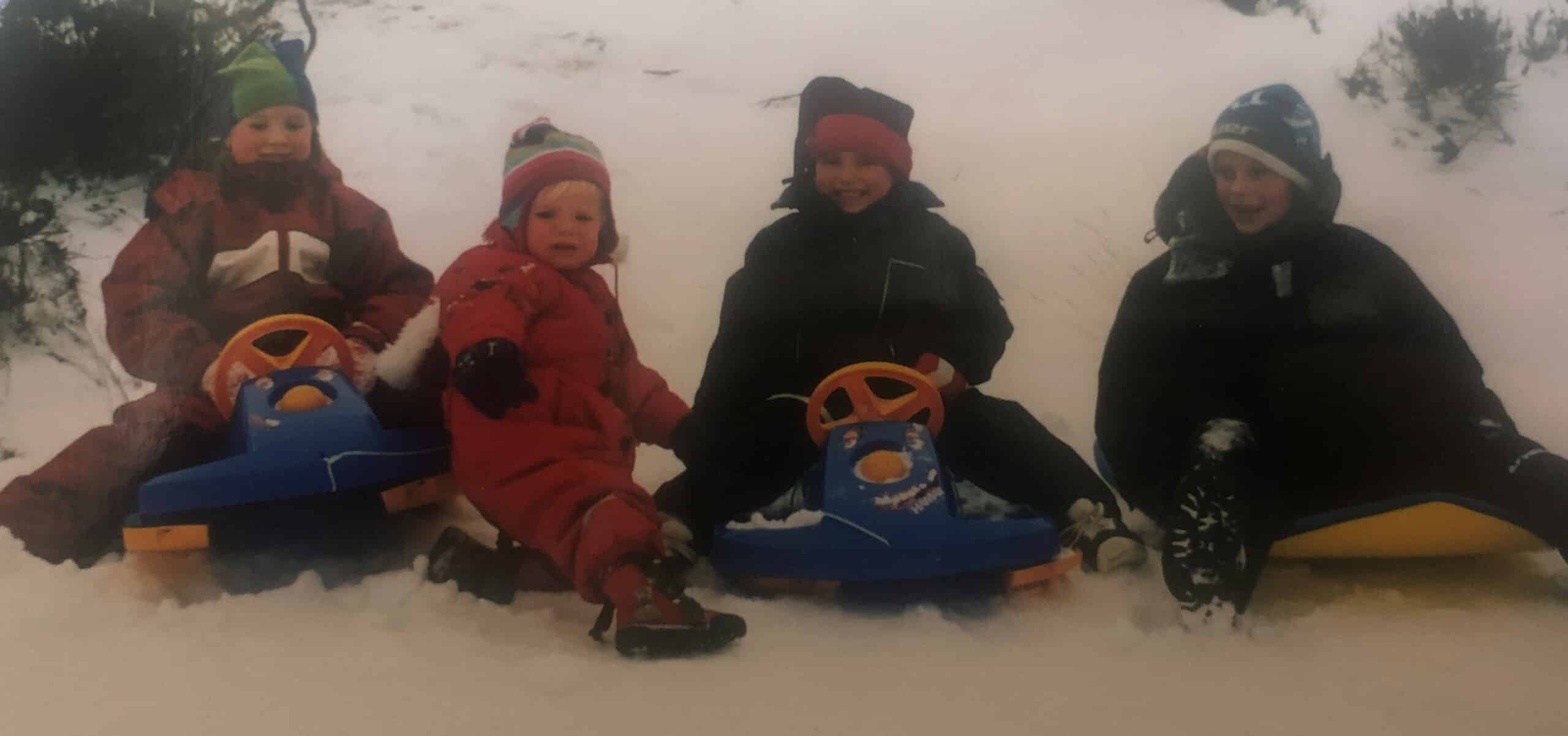 barn med akebrett i snøen