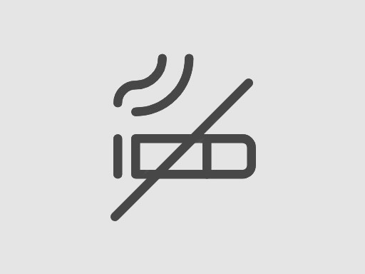 Et røykfritt ikon på en grå bakgrunn.